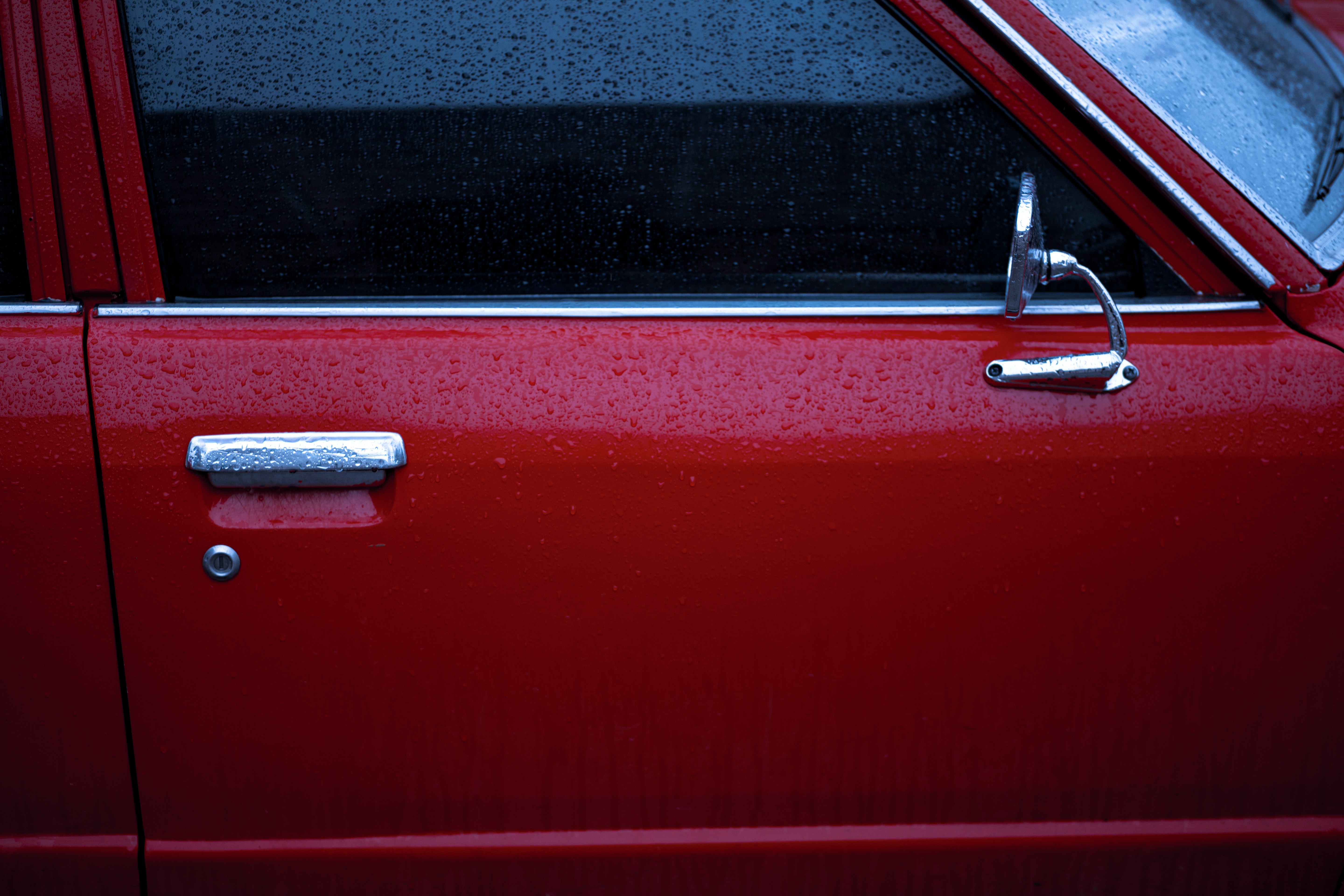 red car with silver door lever